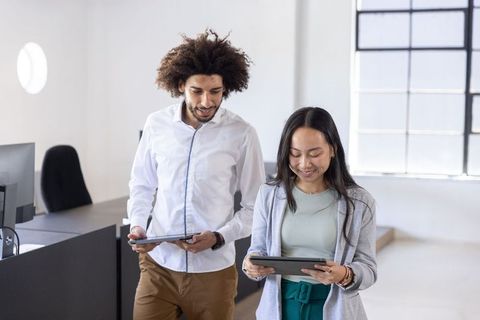 Diverse Coworkers Walking and Collaborating in Modern Office
