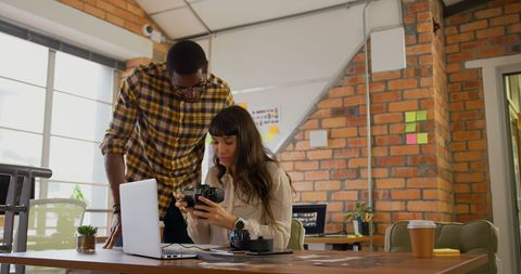 Creative Graphic Designers Collaborating Over Camera Work
