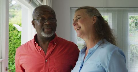 Senior Couple Joyfully Embracing in Home Living Room