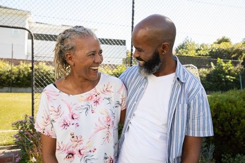 Happy African American Couple Smiling Arm in Arm Outdoors