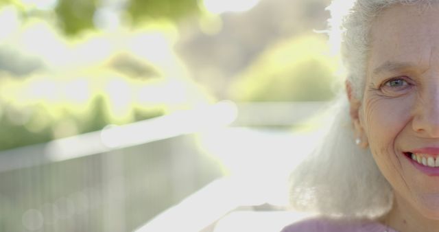 Senior Woman Smiling in Sunlit Park - Download Free Stock Images Pikwizard.com