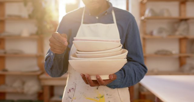 Hands Holding Stack of Ceramic Bowls in Pottery Studio - Download Free Stock Images Pikwizard.com