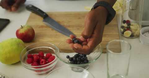 Preparing Refreshing Fruit Smoothie with Raspberries and Blueberries