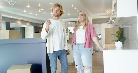 Happy Couple Touring Modern Kitchen in New Home