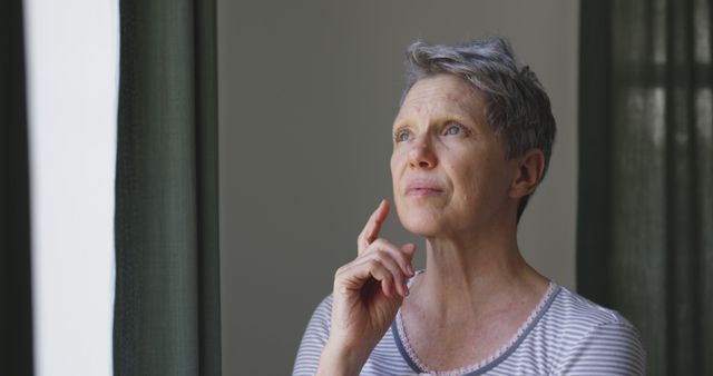 Thoughtful Elderly Woman Looking Out Window Reflecting on Life - Download Free Stock Images Pikwizard.com