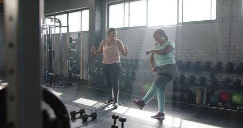 Sunlit Gym Partners Training Together for Warm-Up and Strength, Body-Positive Fitness