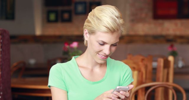 Smiling Woman Using Smartphone in Coffee Shop - Download Free Stock Images Pikwizard.com