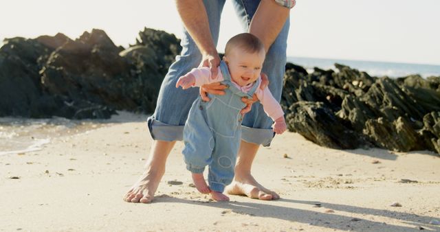 Baby Learning to Walk with Father's Support on Beach - Download Free Stock Images Pikwizard.com