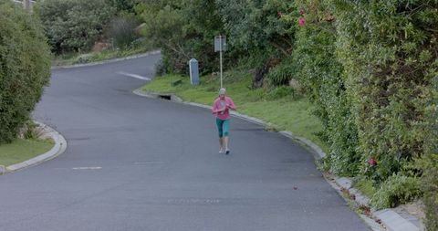 Senior Woman Jogging in Peaceful Suburban Neighborhood - Download Free Stock Images Pikwizard.com