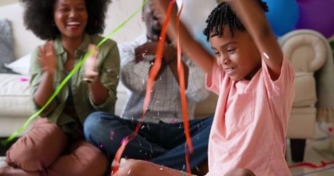 Joyful Family Celebrating Son's Birthday with Colorful Confetti