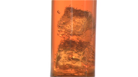 Ice Cubes Slowly Descending in Sparkling Apple Juice