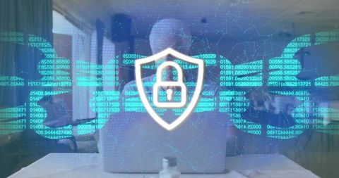 Senior man typing on laptop with holographic cybersecurity shield and data code overlay