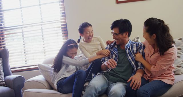 Family bonding at home, laughing together on couch - Download Free Stock Images Pikwizard.com