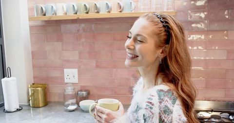 Content Woman Enjoying Coffee in Cozy Modern Kitchen