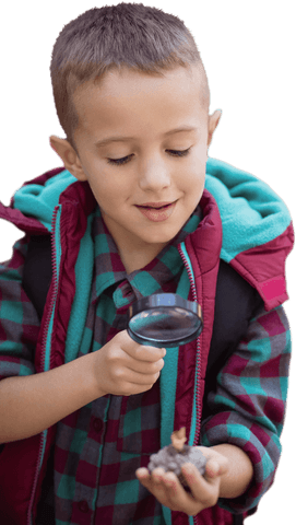 Curious boy examining nature with transparent magnifying glass