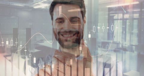 Man drawing stock market charts on glass screen, smiling while interacting with data analytics