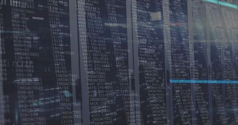 Data center server racks showing console overlays with redacted entries and blue light