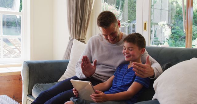 Father and Son Bonding While Using Tablet in Sunny Living Room - Download Free Stock Images Pikwizard.com