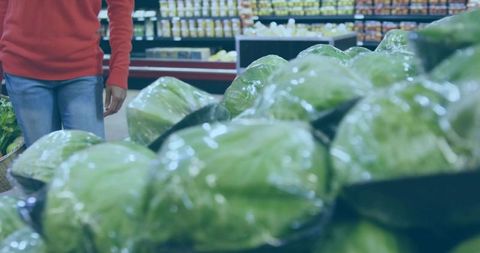 Woman Shopping for Lettuce in Supermarket Produce Aisle