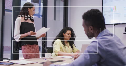 Diverse Business Team Assessing Data in Modern Office