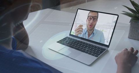 Virtual meeting with colleague on laptop screen