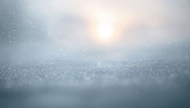 Sparkling Sunlit Frost on Frozen Surface with Falling Snow, Soft Bokeh and Ethereal Glow