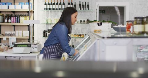 Diligent Waitress in Cafe Restocking Fridge with Goods - Download Free Stock Images Pikwizard.com