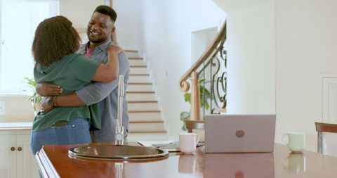 African American Couple Reviewing Papers in Modern Kitchen