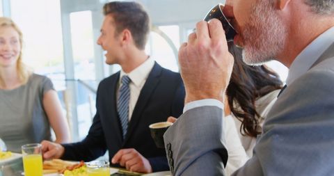 Professional Business Meeting over Coffee in Modern Cafe