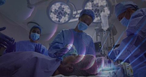 Surgeons conducting operation with anesthesia mask
