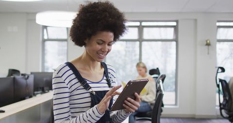 Businesswoman Working on Tablet in Modern Office Setting - Download Free Stock Images Pikwizard.com