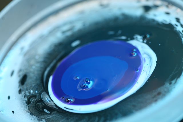 Close up view of blue paint in a liquid. art and background concept