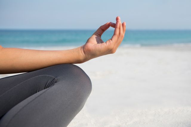 Woman Meditating on Beach in Lotus Position - Download Free Stock Photos Pikwizard.com