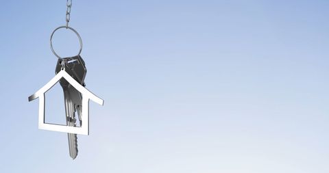 Silver house keychain on blue gradient background