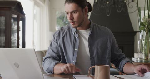 Remote work at home office with laptop and coffee mug