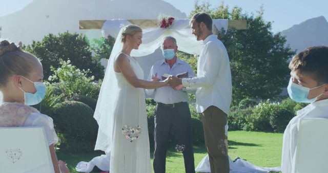 Bride and Groom Exchange Vows Wearing Masks Outdoors - Download Free Stock Images Pikwizard.com