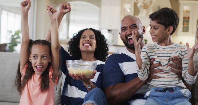 Happy Family Celebrating on Couch with Snacks - Download Free Stock Images Pikwizard.com