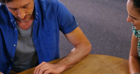 Business professionals collaborating over digital tablet