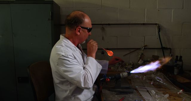 Glassmaker Shaping Molten Glass with Blowtorch in Workshop - Download Free Stock Images Pikwizard.com