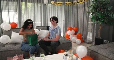 Happy Multiethnic Couple Celebrating Birthday with Gifts