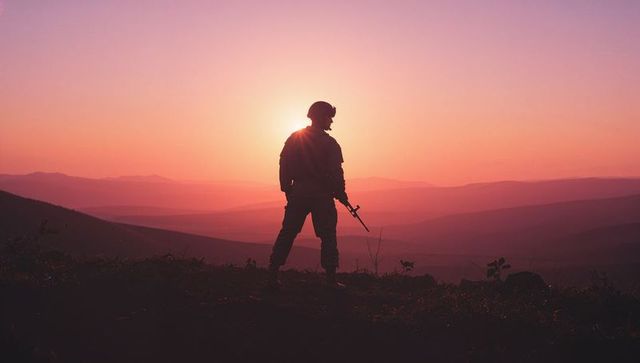Soldier in Silhouette at Dawn: Embodying Strength and Resilience