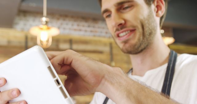 Barista Smiling While Using Digital Tablet in Modern Cafe - Download Free Stock Images Pikwizard.com