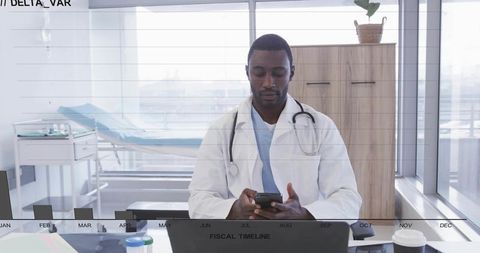 Doctor checking smartphone at desk with fiscal timeline overlay in clinic