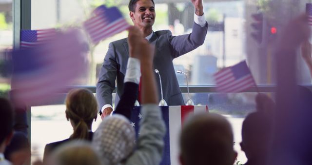 Politician addressing crowd during campaign rally with American flags - Download Free Stock Images Pikwizard.com