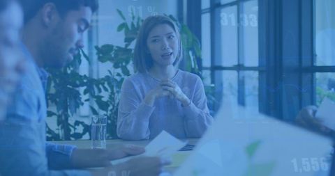 Diverse Business Team Discussing Financial Report in Modern Office