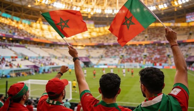 Cheering moroccan fans waving flags in stadium during international soccer match