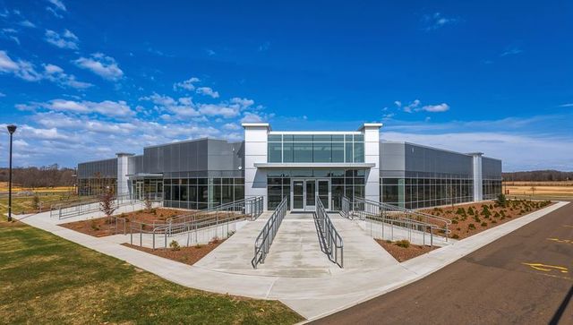 Modern eco-friendly corporate building with glass facade and accessibility features