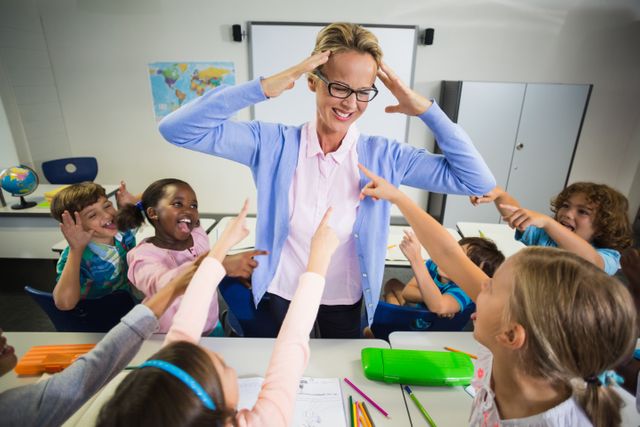 Frustrated Teacher Surrounded by Energetic Students in Classroom - Download Free Stock Photos Pikwizard.com