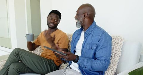 Father and son sharing moments with tablet