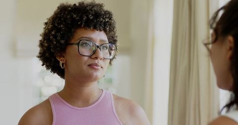 Woman with glasses conversing in a casual home setting